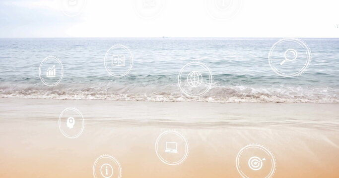 Displaying overlays merging with sandy shore on beach, with analytics, laptop and information icons