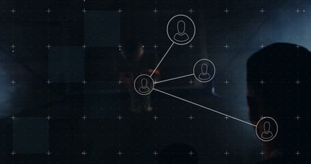 Male silhouette monitoring network diagram in control room, with floating user icons, copy space