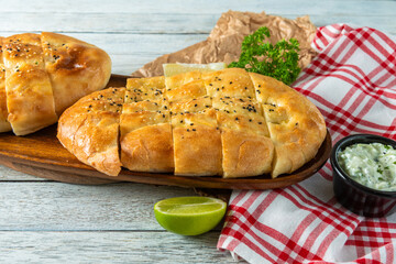 Savory Bread Loaf on Wooden Platter With Lime