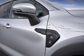 Fototapeta premium Close-up of a damaged silver SUV side