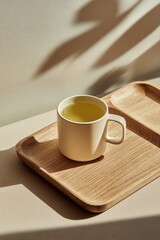 Obraz premium Minimalist Tea Presentation: A Cup of Green Tea on Wooden Tray, Shadow Play, Soft Lighting