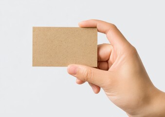 Hand holding a kraft business card