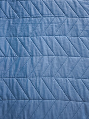Naklejka premium Blue quilted fabric texture creating a diamond pattern background