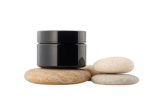 Black cosmetic jar sitting on smooth river stones creating zen spa wellness atmosphere, isolated on a transparent background