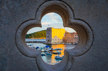 Sunset panoramic view on walls and port of famous old city Dubrovnik, Croatia