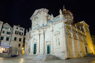 Cozy street and old city walls at night in Dubrovnik, Croatia