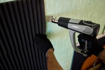 Applying Soundproof Foam Panels Securely Using a Hot Glue Gun for Better Performance and Insulation