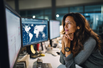 Mature Hispanic businesswoman analyzing cross-border shipping issues, comparing