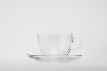 A pristine teacup and saucer, ready to embrace the warmth of your favorite brew. 