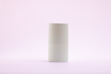 A clean and simple studio shot of a white cylindrical object, isolated on a light, neutral background.