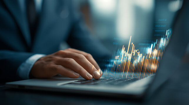 Person in suit using laptop with glowing financial chart overlay business finance - Powered by Adobe