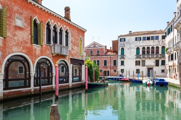 View of the unique and characteristic Venetian canals, where typical boats knew as Gondola are used for tourist sightseeing. Worldwide famous, Venezia is a unique kind of city and UNESCO site.