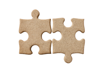 Two light beige puzzle pieces, closely joined, on a black background