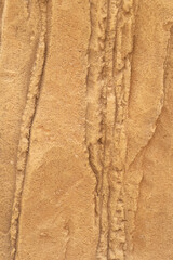 Sand stone wall ridged textured gritty yellow wet dry background