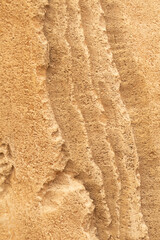 Sand stone wall ridged textured gritty yellow wet dry background