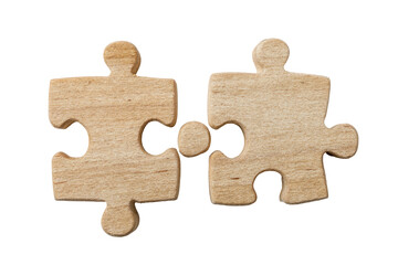 Fototapeta premium Two light brown wooden jigsaw puzzle pieces fitting together