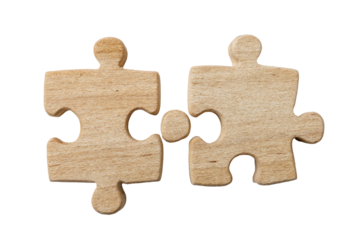 Two light brown wooden jigsaw puzzle pieces fitting together