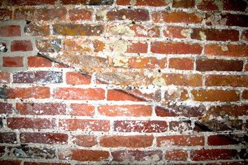 Close up of old weathered bricks outside in dark reds