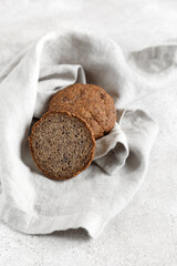 Whole grain bread with seeds, sliced half wholemeal bread on a plate. Healthy nutrition, bio organic food.