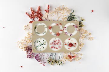Silicone mold for aroma sachet with dried flowers with coconut or organic soy wax. Flatlay.