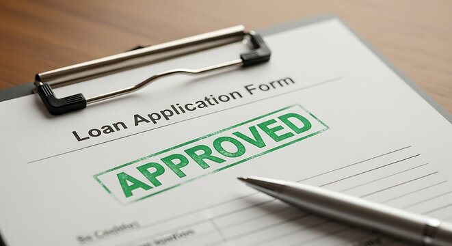 Loan application form with approved stamp and pen on a desk, representing financial approval and successful borrowing