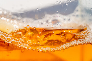 Close up bright orange Oil or beer splash texture and nature waves, Beautiful waves curve and little bubbles smooth for graphic design and background, Oil Bubbles, Soft beer bubbles, Selective focus