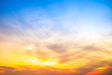 Obraz premium Beautiful , luxury soft gradient orange gold clouds and sunlight on the blue sky perfect for the background, take in evening,Twilight, Large size, high definition landscape photo