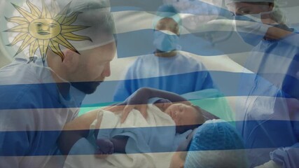 Nurse handing newborn to father for bonding in hospital while flag overlay waves across scene - Powered by Adobe