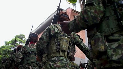 Armed soldiers ready for war, military troops with rifles, combat-ready infantry forces. High quality FullHD footage - Powered by Adobe