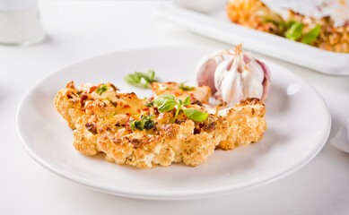 Cauliflower steak with spices and herbs. Healthy vegan organic cuisine.