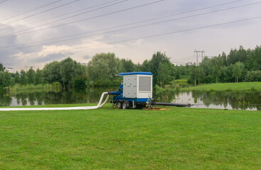 mobile pump trailer pumps water out of a park flooded during the rains