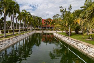 Palm-lined canal with fountain in Wat Yai Chai Mongkhon, Ayutthaya, Thailand