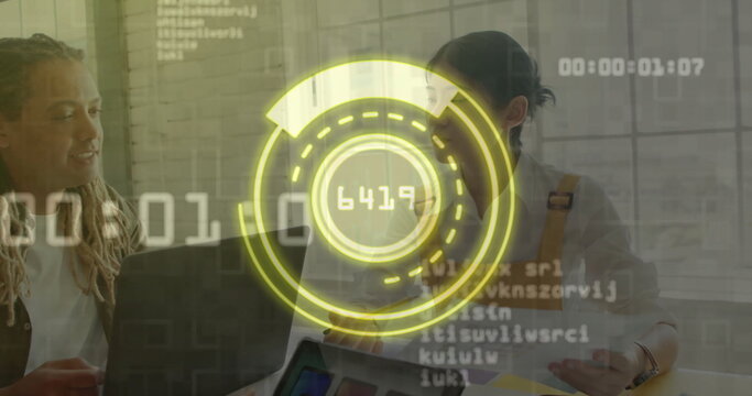 Colleagues working in modern office, reviewing data on laptop and charts with holographic interface - Powered by Adobe