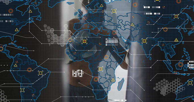 Operating touchscreen Black male wearing smartwatch in office, with map and colored data nodes