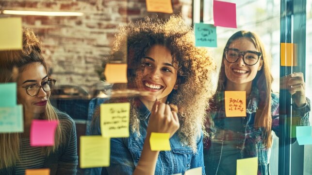 Young women brainstorming with sticky notes in a bright office space