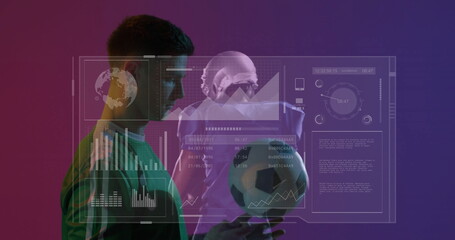 Cradling athlete wearing green jersey and holding soccer ball in studio with analytics overlay