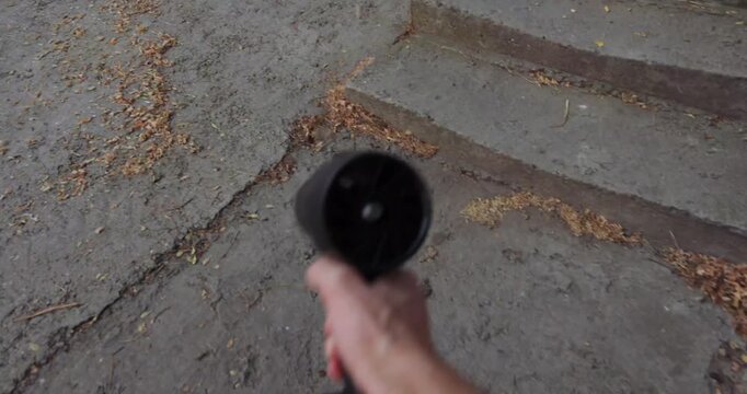 POV, blowing away garbage and leaves on the street with a turbo fan