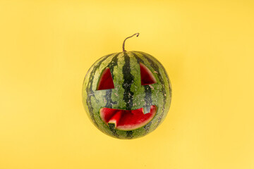 Summerween, festive background for funny summer holiday in style of Halloween with summer decorations, watermelon and pumpkins
