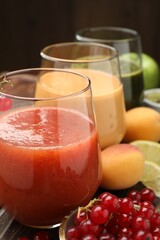 Superfood. Tasty smoothies in glasses and ingredients on table, closeup