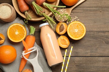 Superfood. Tasty smoothie in bottle and ingredients on wooden table, flat lay