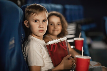 Kids watching movie at the cinema with popcorn