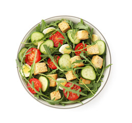 Tasty salad with croutons, cucumbers, tomatoes and arugula isolated on white, top view