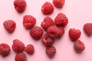 Tasty fresh ripe raspberries on pink background, flat lay