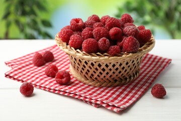 Tasty fresh ripe raspberries on white wooden table, closeup