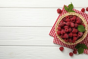 Tasty fresh ripe raspberries and leaves on white wooden table, flat lay. Space for text © New Africa