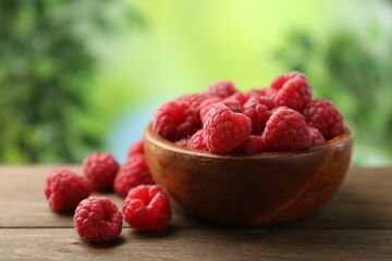 Tasty fresh ripe raspberries on wooden table, closeup
