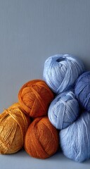 Stacked balls of vibrant yarn in blue and orange hues