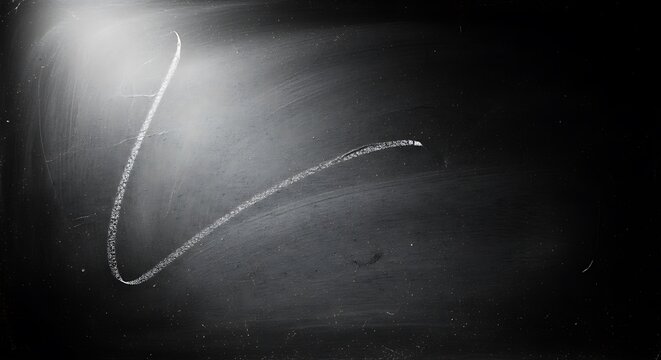 A chalk line curves across a dark textured surface with bright light