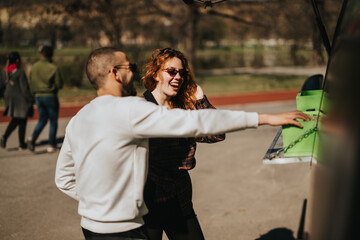 A cheerful moment of friends socializing and interacting at an outdoor park setting.