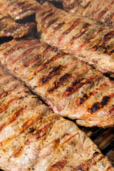 The process of cooking meat on a charcoal grill. A Summer Cooking Scene